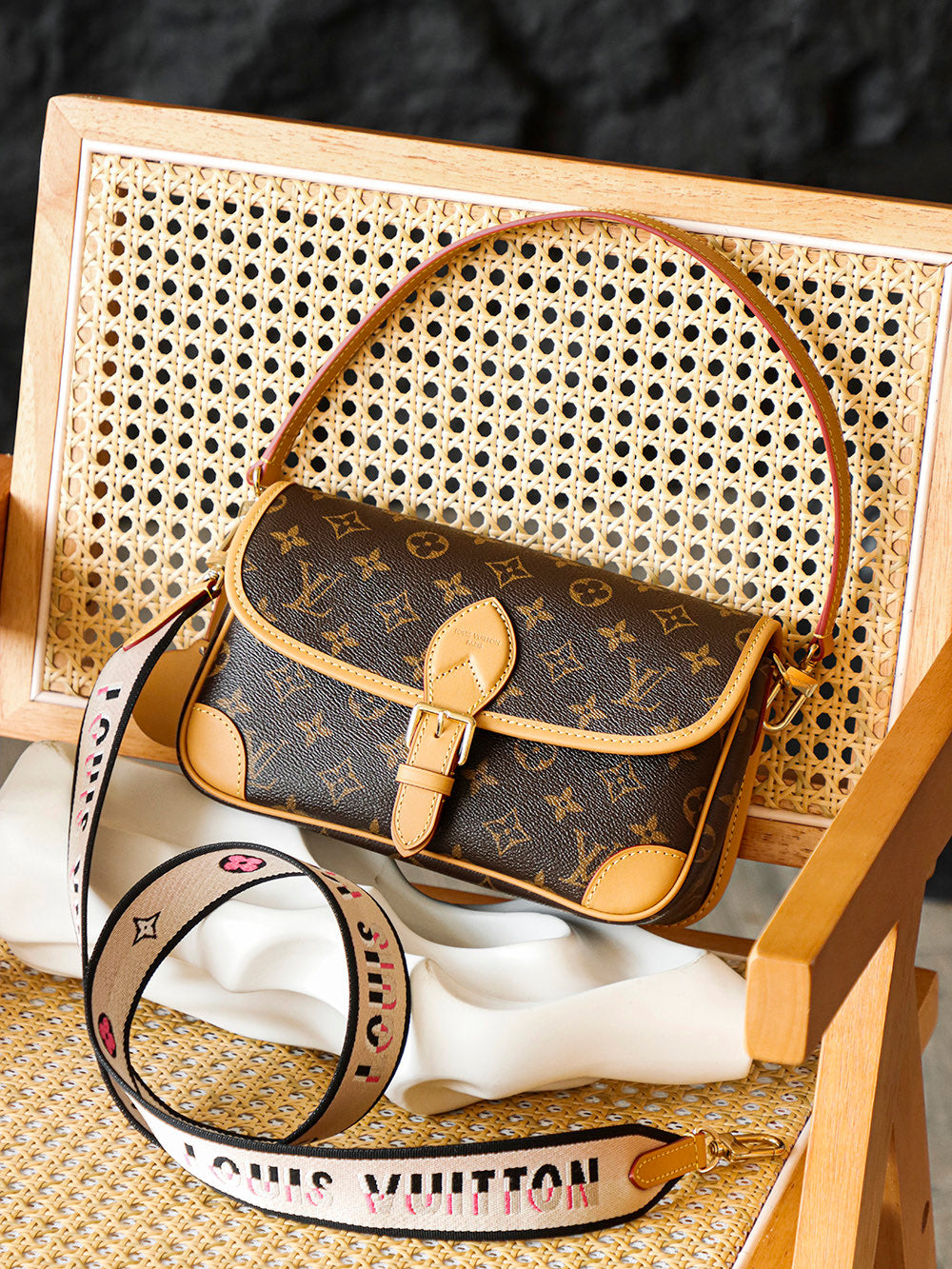 Second hand Louis Vuitton luxury bag with baguette bag featuring a simple yet unique jacquard wide shoulder strap design
